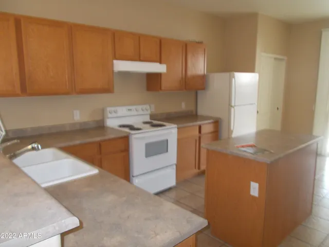 a kitchen with a stove and a sink
