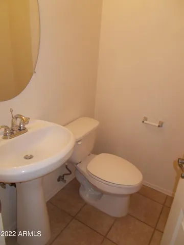 a white toilet sitting next to a white sink