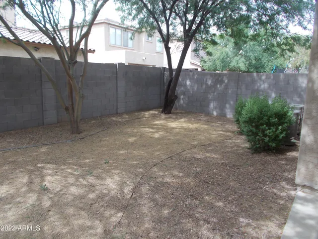 a backyard of a house with plants and trees