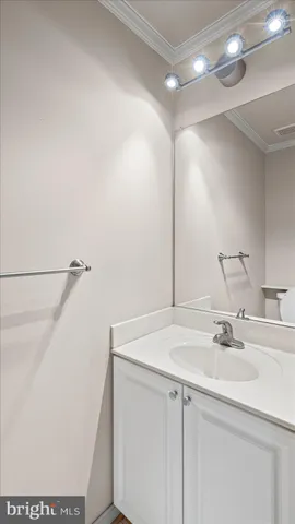 a bathroom with a sink vanity and a mirror