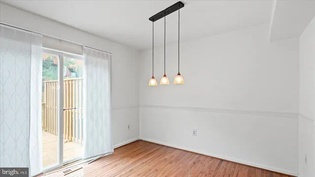 a view of a room with wooden floor and window
