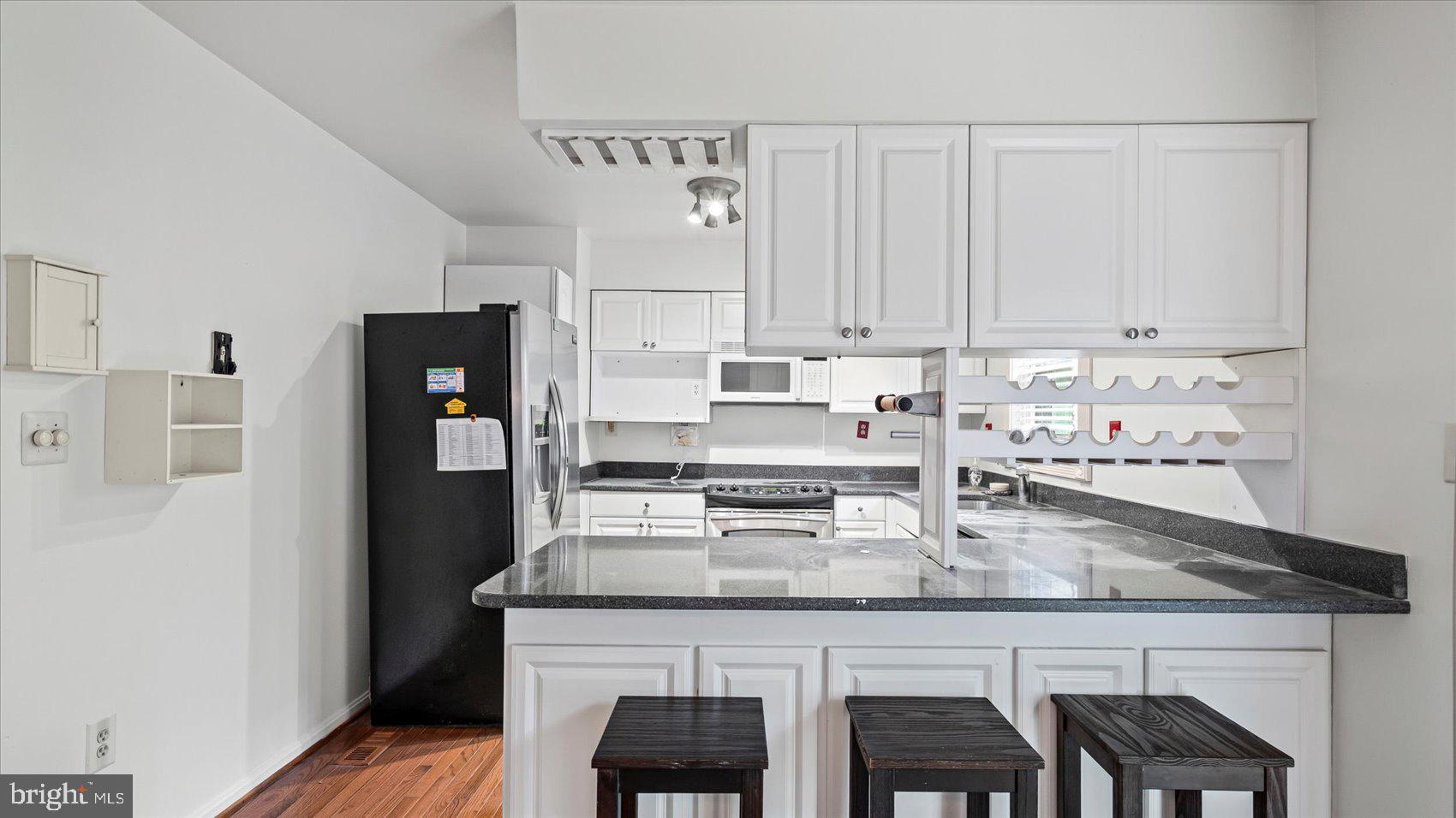 12 Mayapple Court Towson, MD 21286 - Photo 15 of 41 a kitchen with stainless steel appliances granite countertop a table chairs stove and refrigerator