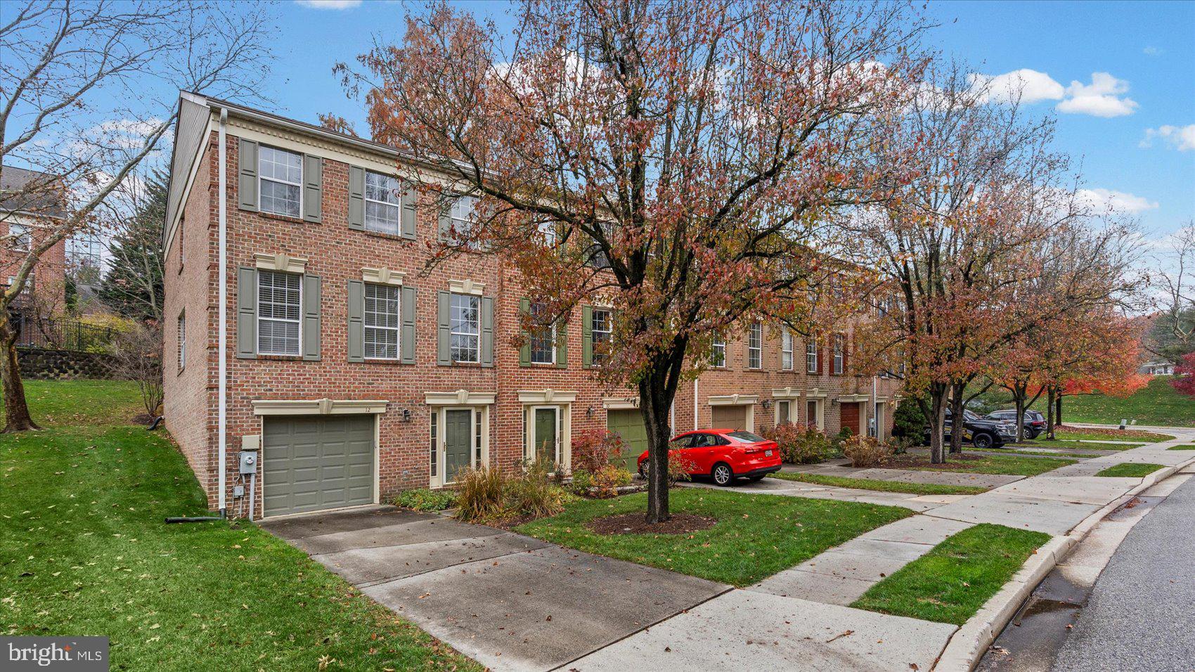 12 Mayapple Court Towson, MD 21286 - Photo 2 of 41 a view of a yard in front of a brick house with a large tree