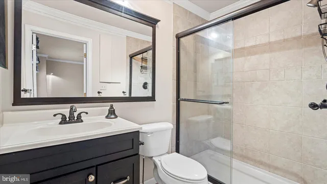 a bathroom with a sink toilet a mirror and shower