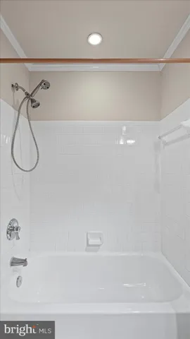 a bathroom with a bath tub with a shower