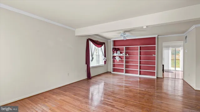 an empty room with wooden floor and closet