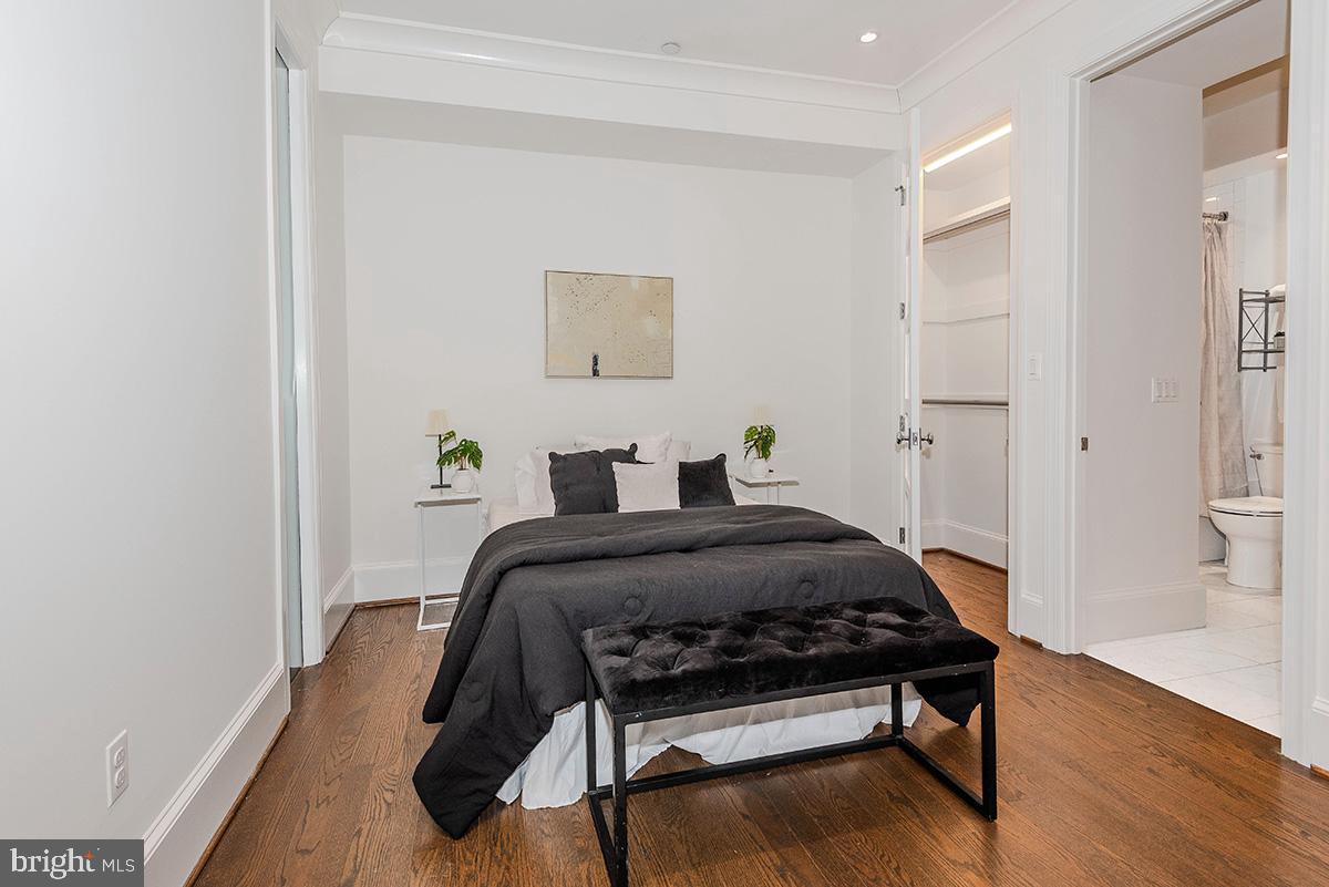 418 7th Street Southeast, Unit 302 Washington, DC 20003 - Photo 12 of 35 a bedroom with a bed and wooden floor