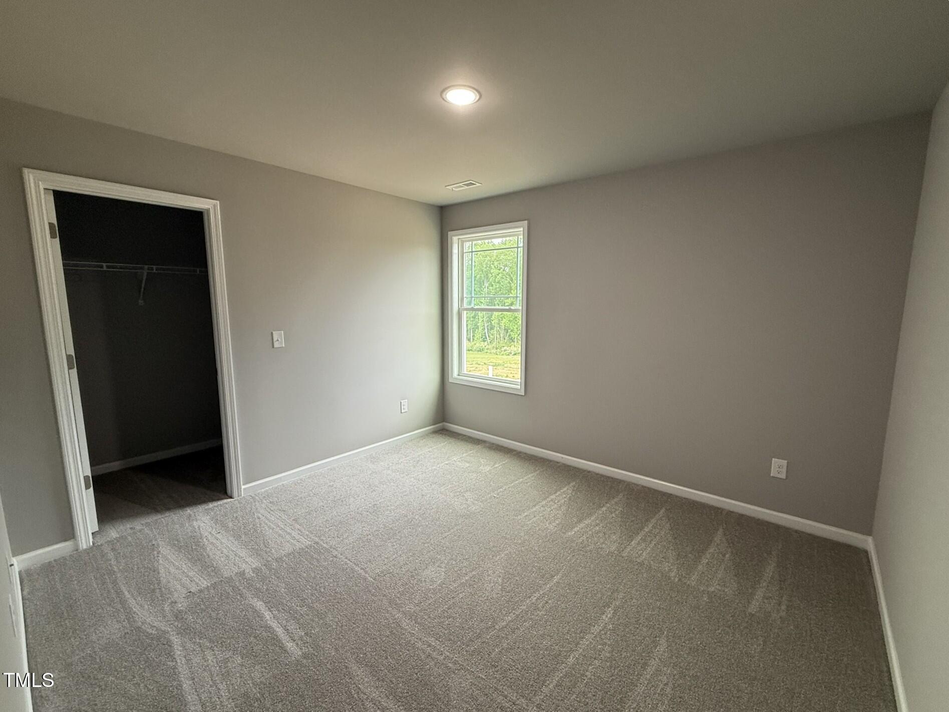 146 Starry Sky Drive Benson, NC 27504 - Photo 13 of 16 a view of an empty room with a window