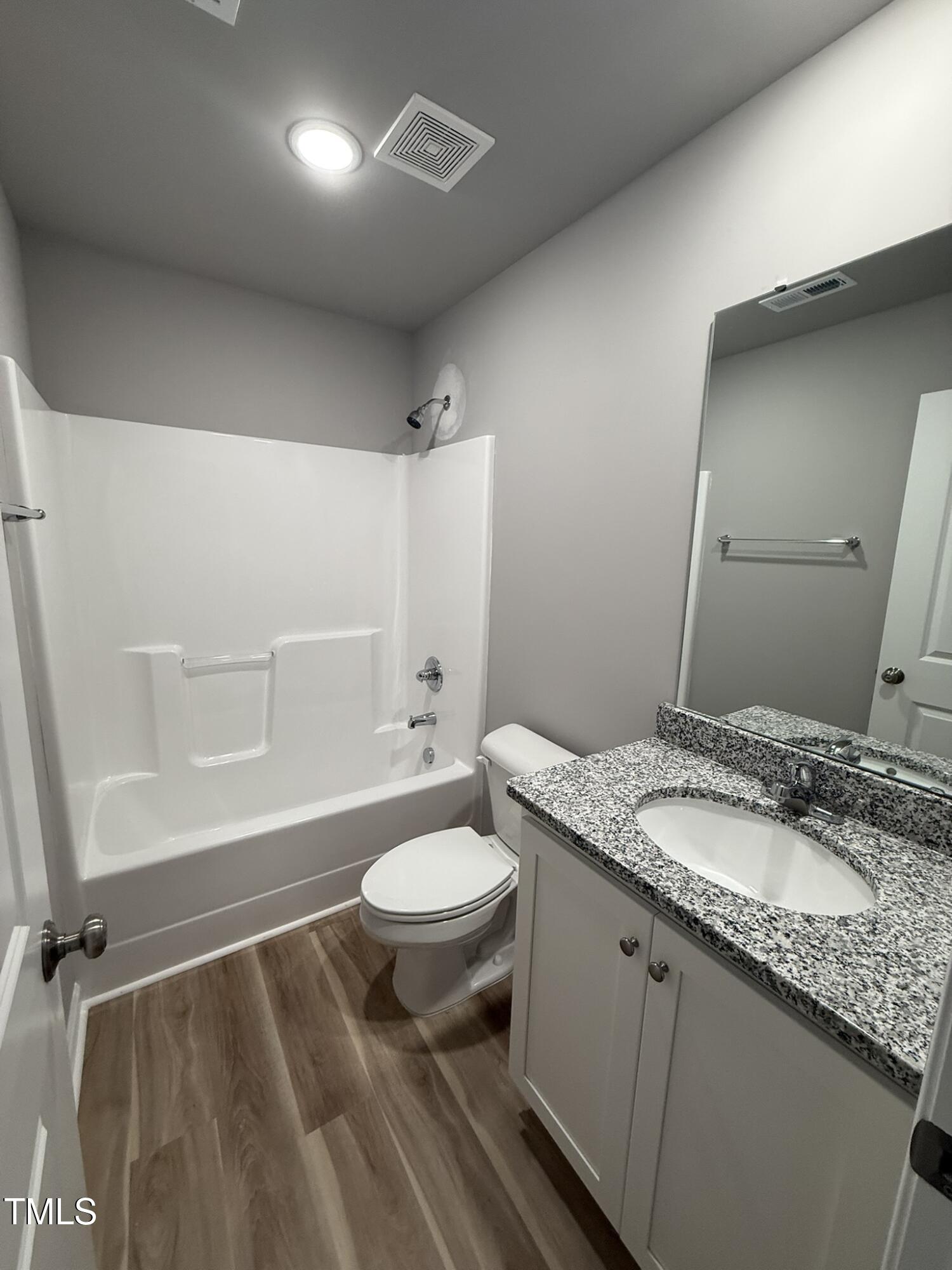 146 Starry Sky Drive Benson, NC 27504 - Photo 14 of 16 a bathroom with a granite countertop sink toilet a large mirror and shower