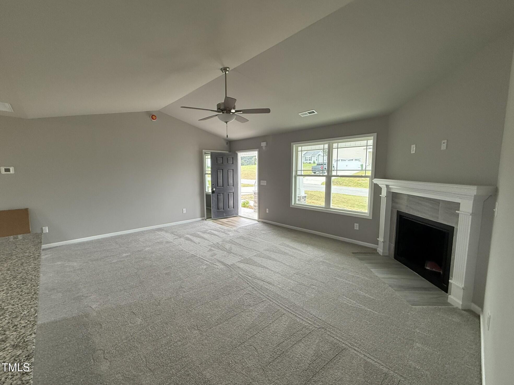 146 Starry Sky Drive Benson, NC 27504 - Photo 3 of 16 a view of an empty room with chandelier and fireplace