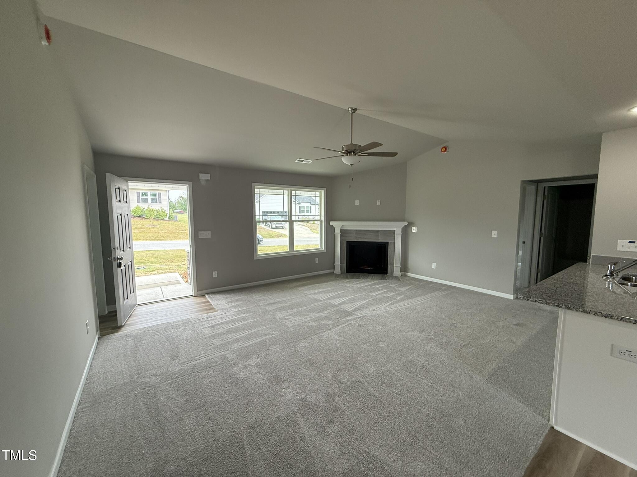 146 Starry Sky Drive Benson, NC 27504 - Photo 4 of 16 a view of an empty room with a window and fireplace