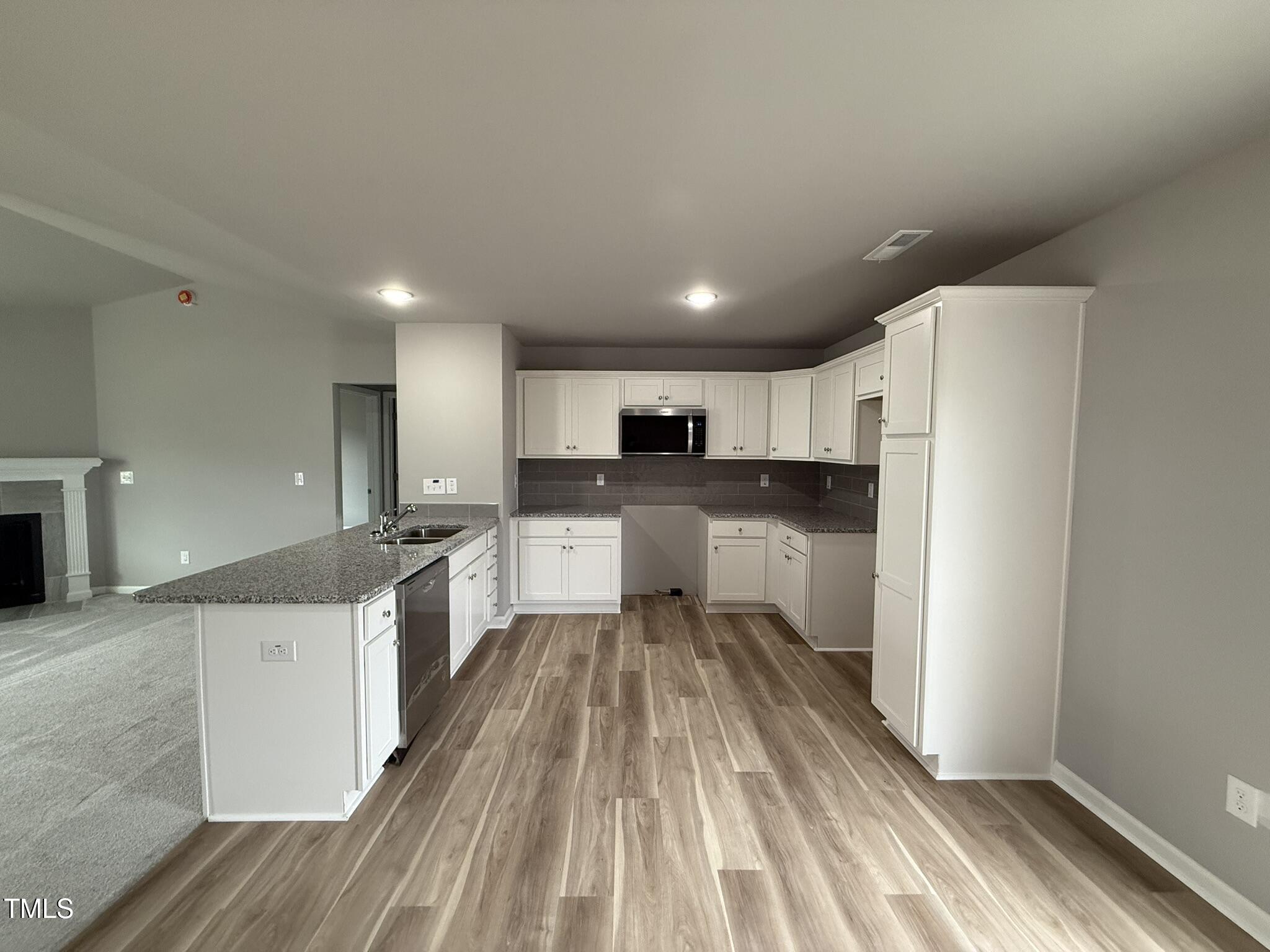 146 Starry Sky Drive Benson, NC 27504 - Photo 7 of 16 a large kitchen with a lot of counter space and stainless steel appliances