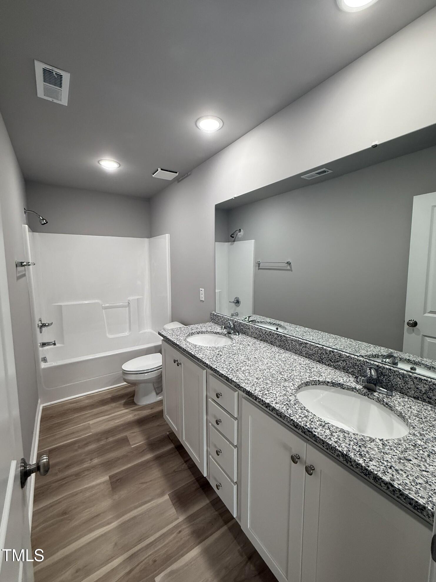 146 Starry Sky Drive Benson, NC 27504 - Photo 10 of 16 a bathroom with a granite countertop sink and a mirror