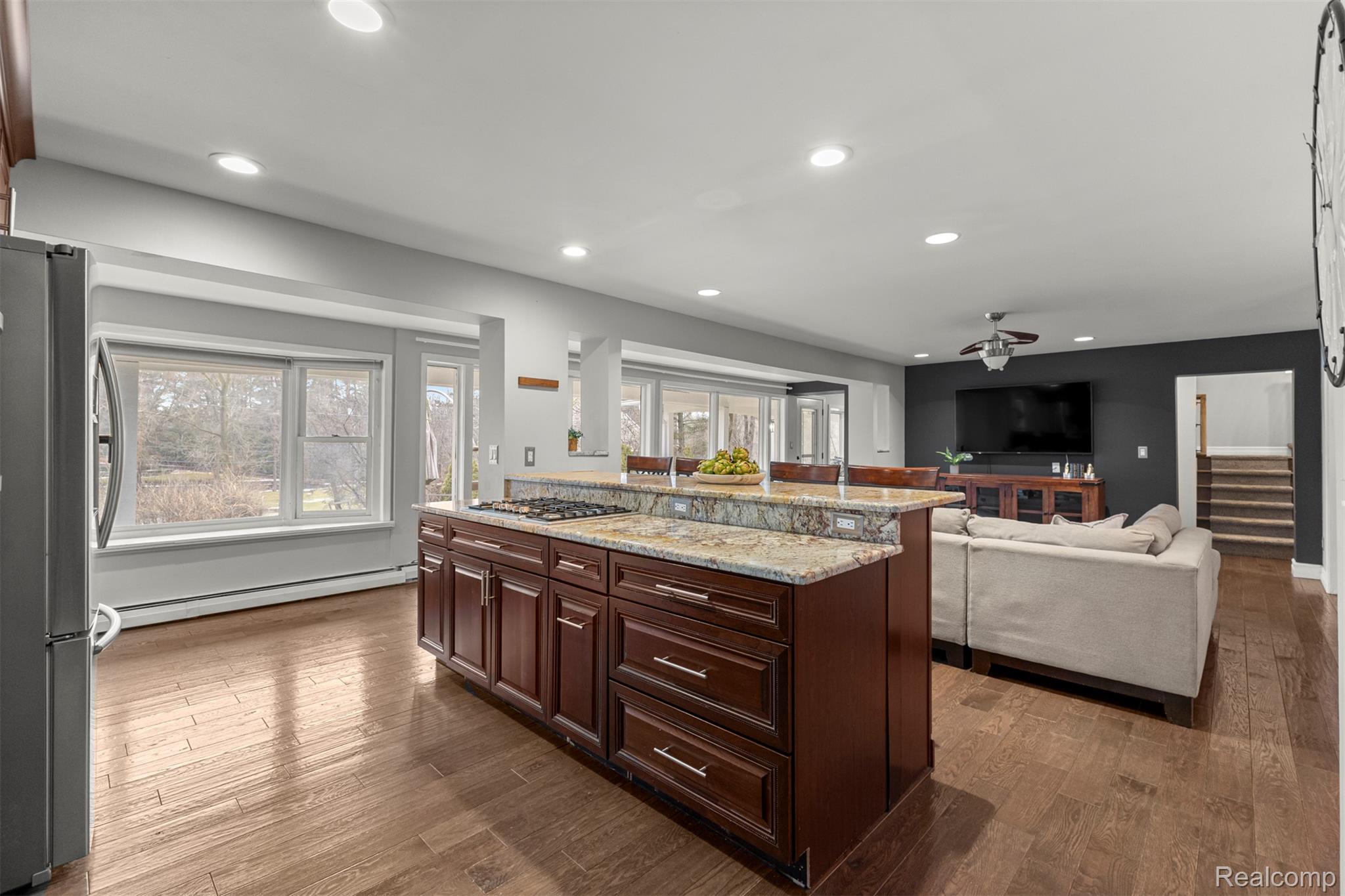 45401 West 9 Mile Road Novi, MI 48374 - Photo 14 of 67 Kitchen featuring appliances with stainless steel finishes, light stone countertops, dark wood-style flooring, a baseboard radiator, and recessed lighting