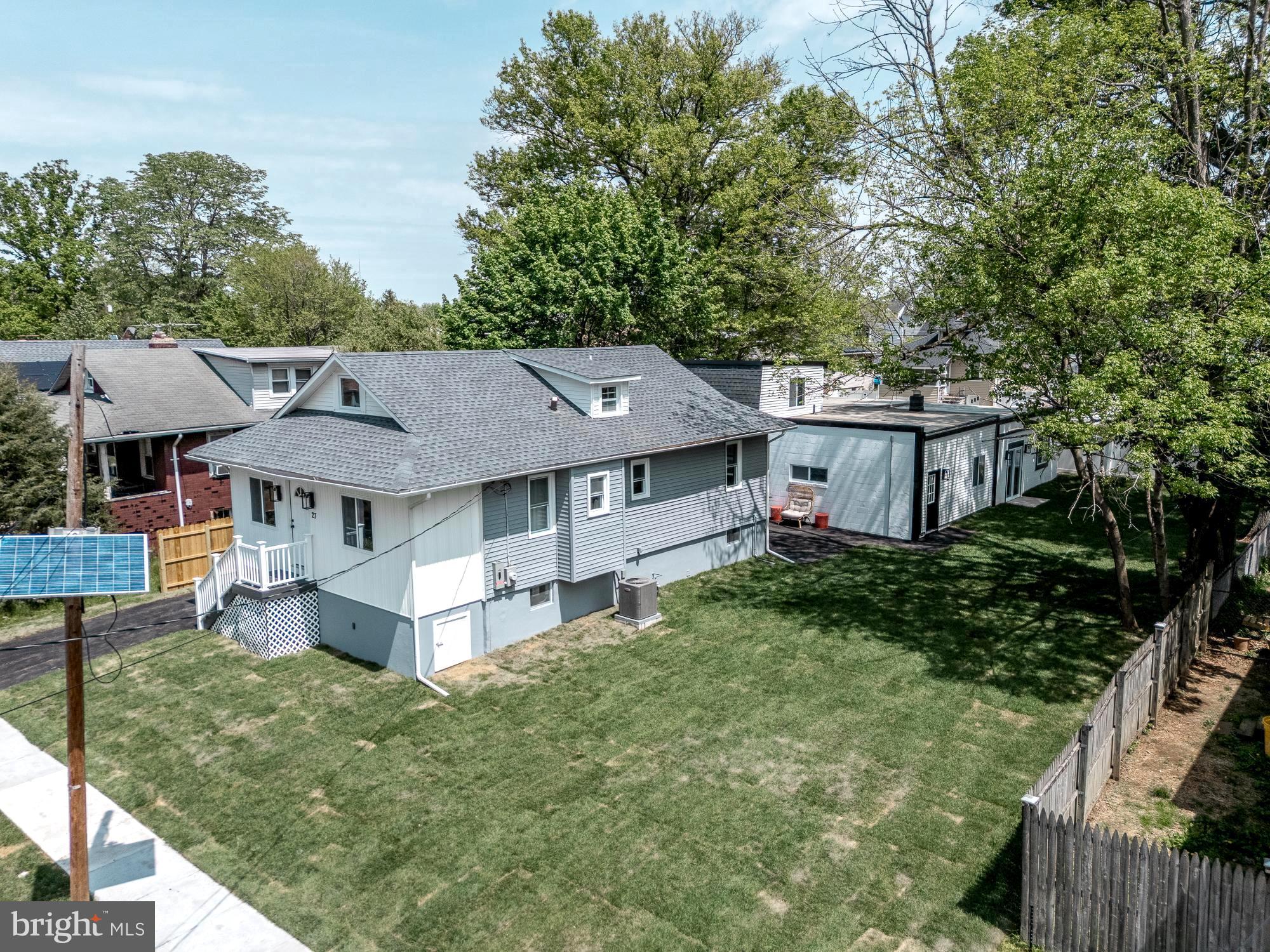 a aerial view of a house with a big yard plants and large trees