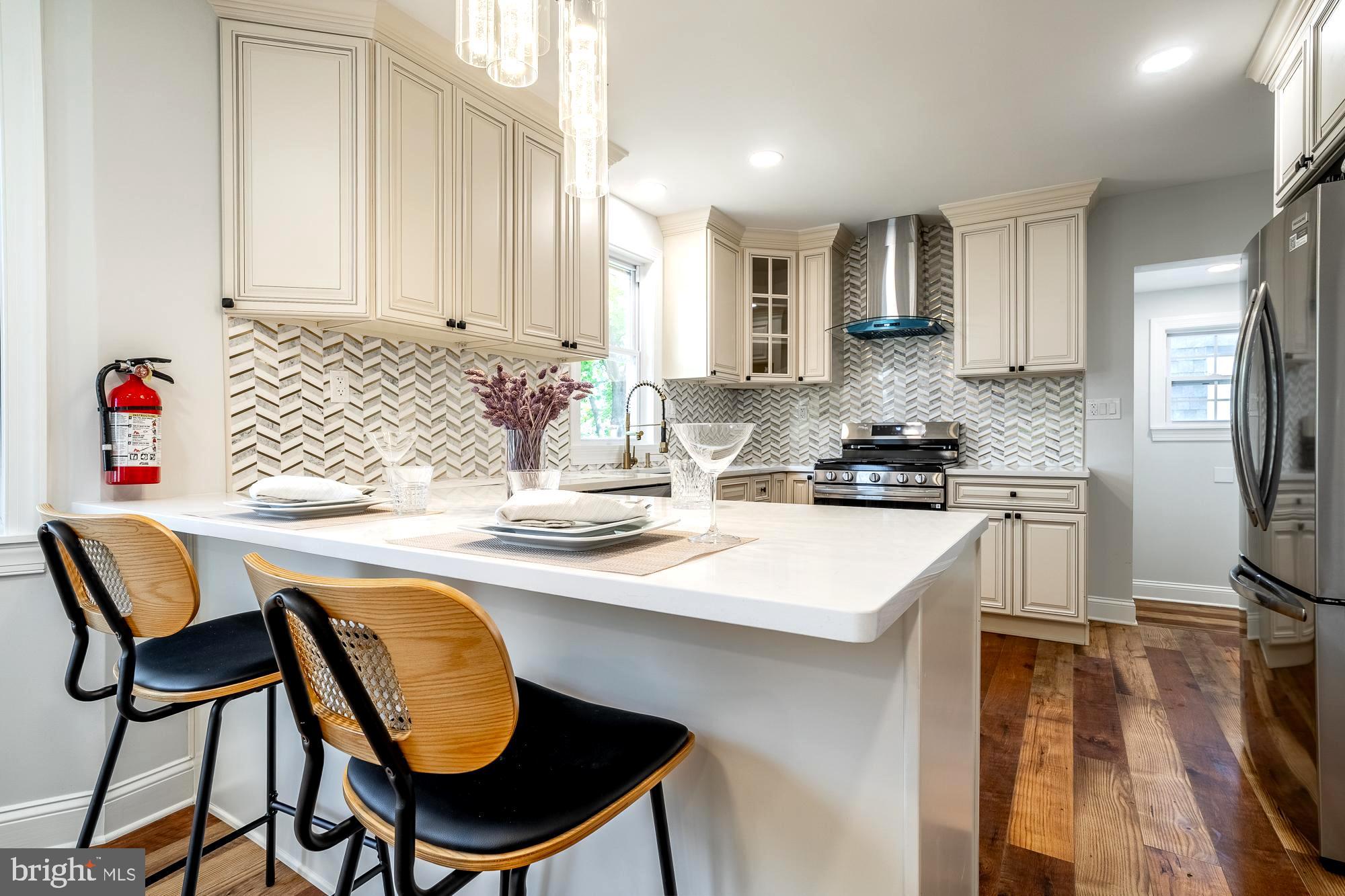 27 Cherry Avenue Maple Shade, NJ 08052 - Photo 12 of 50 a kitchen with a dining table chairs and refrigerator