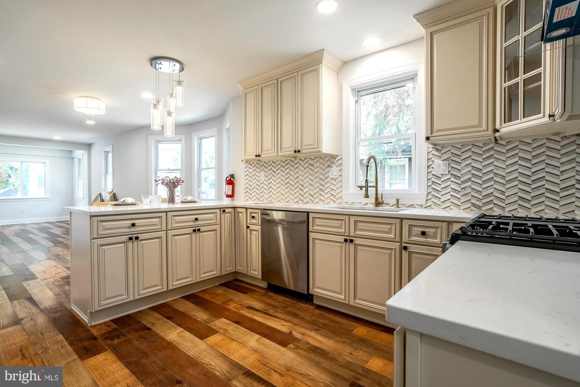 27 Cherry Avenue Maple Shade, NJ 08052 - Photo 13 of 50 a kitchen with a sink stove and cabinets