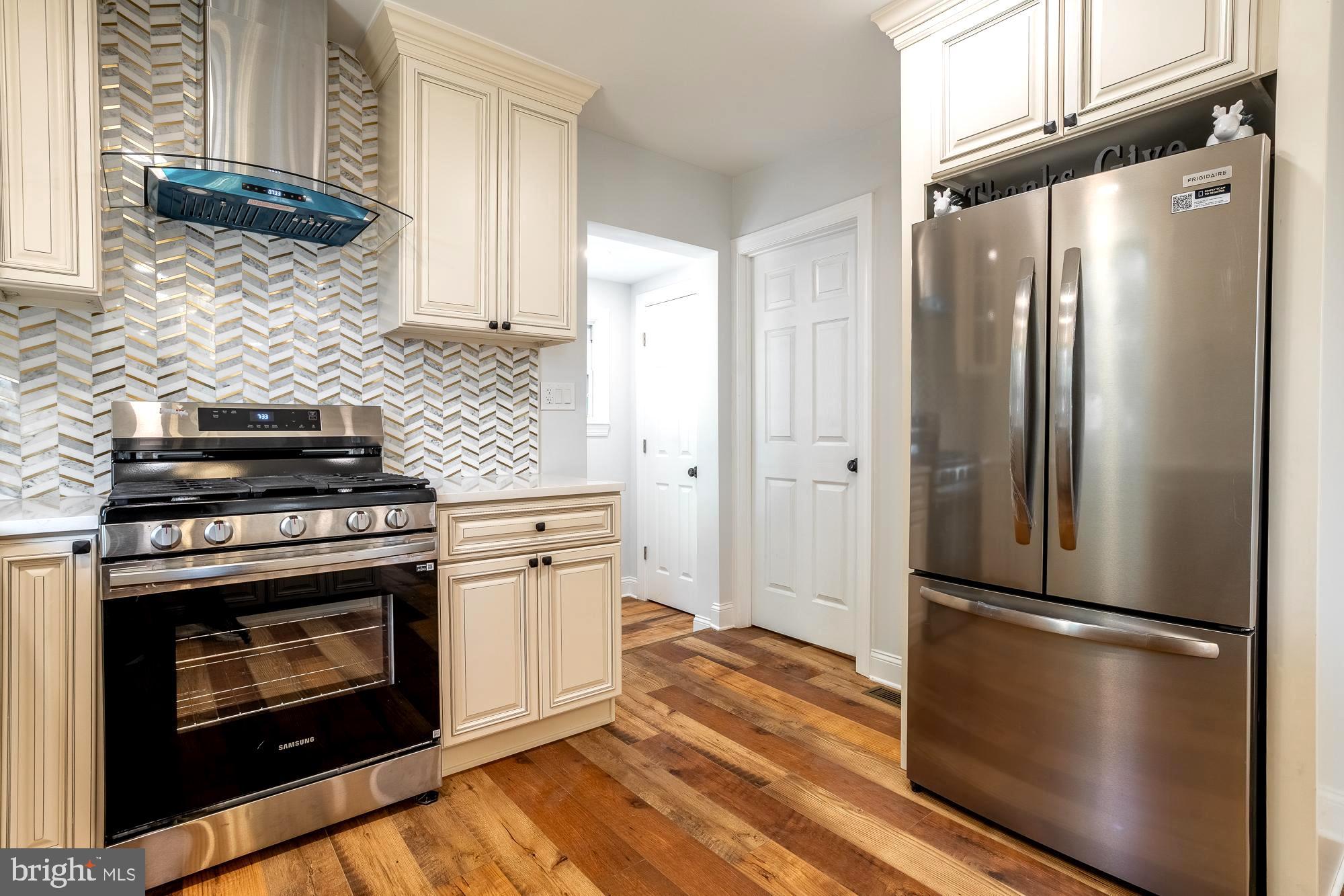 27 Cherry Avenue Maple Shade, NJ 08052 - Photo 14 of 50 a kitchen with a refrigerator stove and white cabinets