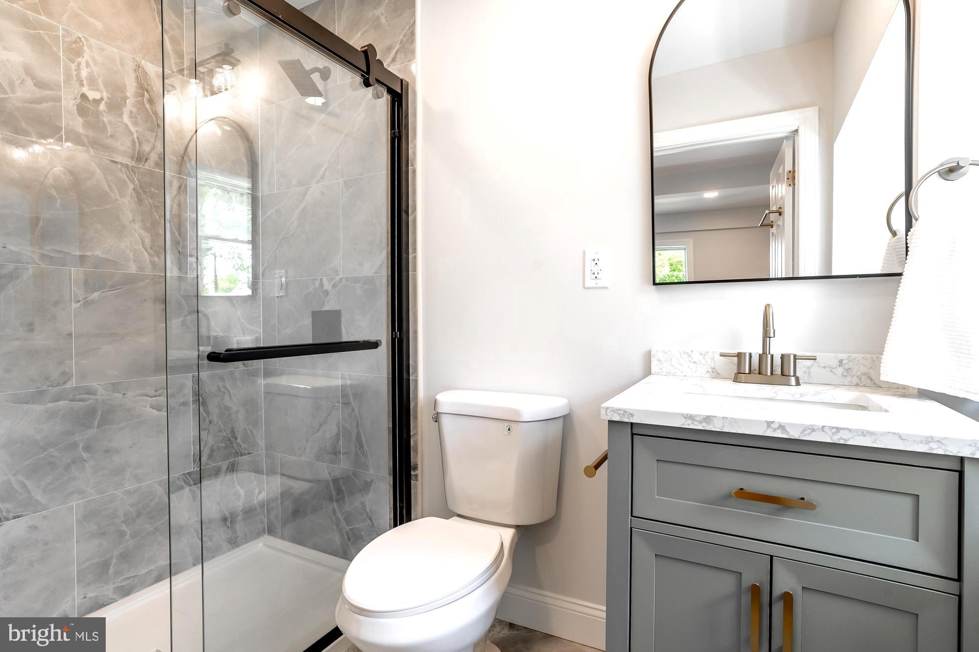 27 Cherry Avenue Maple Shade, NJ 08052 - Photo 17 of 50 a bathroom with a granite countertop sink toilet a mirror and shower