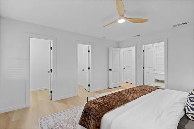 a bedroom with a bed and a chandelier