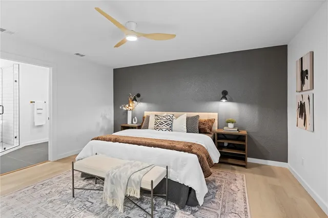 a bedroom with a bed and a night stand