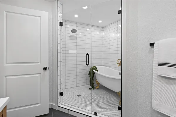 a bathroom with a bathtub and a shower