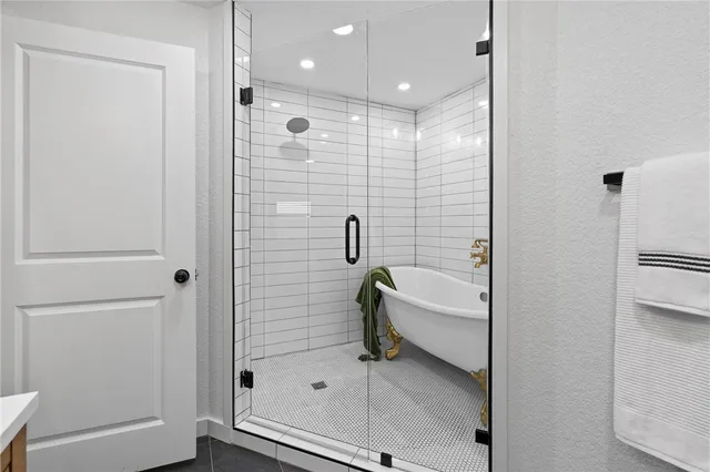 a bathroom with a bathtub and a shower