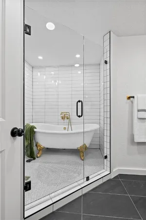 a bathroom with a shower and a bath tub