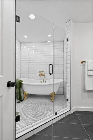 a bathroom with a shower and a bath tub