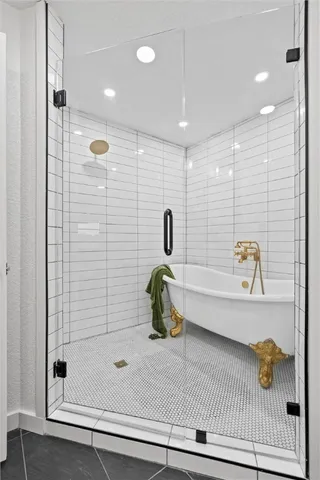 a bathroom with a tub and shower