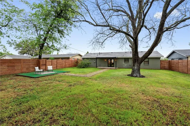 a view of a chairs in a backyard