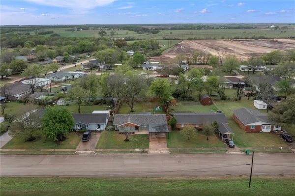 an aerial view of a house with a yard