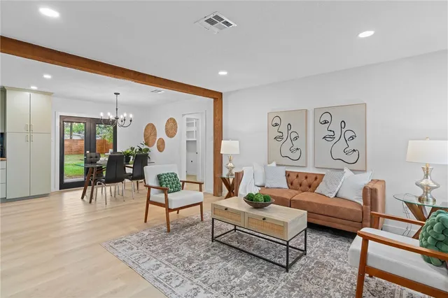 a living room with furniture and wooden floor