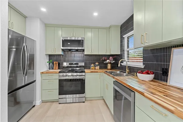 a kitchen with a sink stove and refrigerator