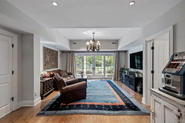 a living room with furniture large window and a flat screen tv
