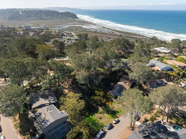 an aerial view of house with yard and mountain view in back