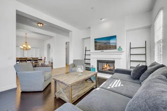 a living room with furniture a flat screen tv and a fireplace