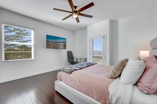 a bathroom with a granite countertop sink a toilet and a mirror