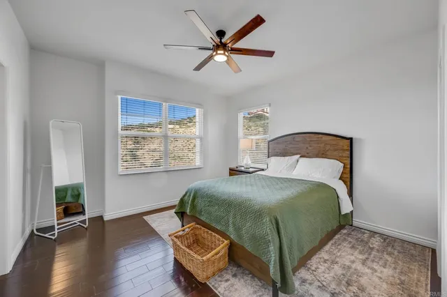 a bedroom with a bed and a table in it with window