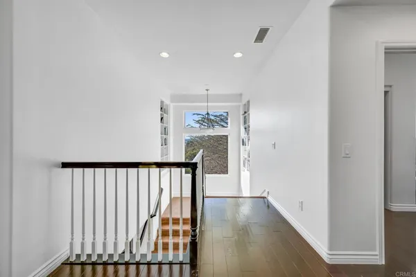 a large kitchen with stainless steel appliances lots of counter space and windows