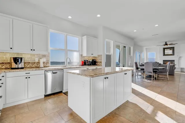 a view of a big house with a big yard and large trees