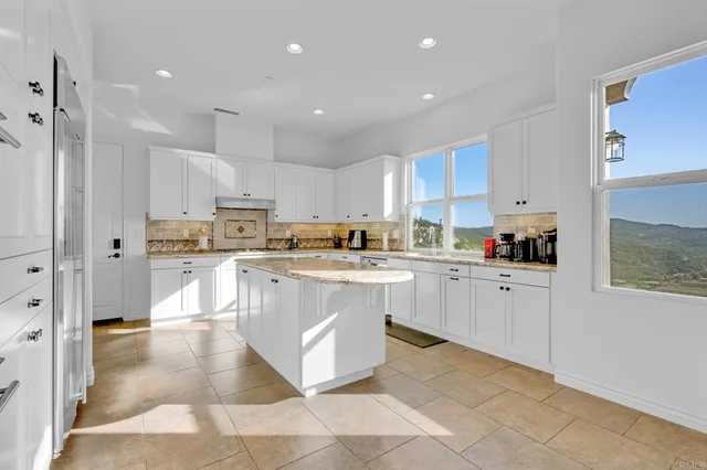 a kitchen with cabinets and stainless steel appliances