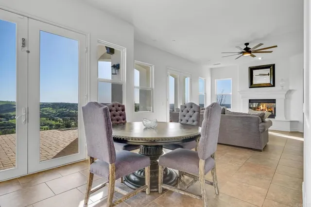 a view of a dining room with furniture and a chandelier