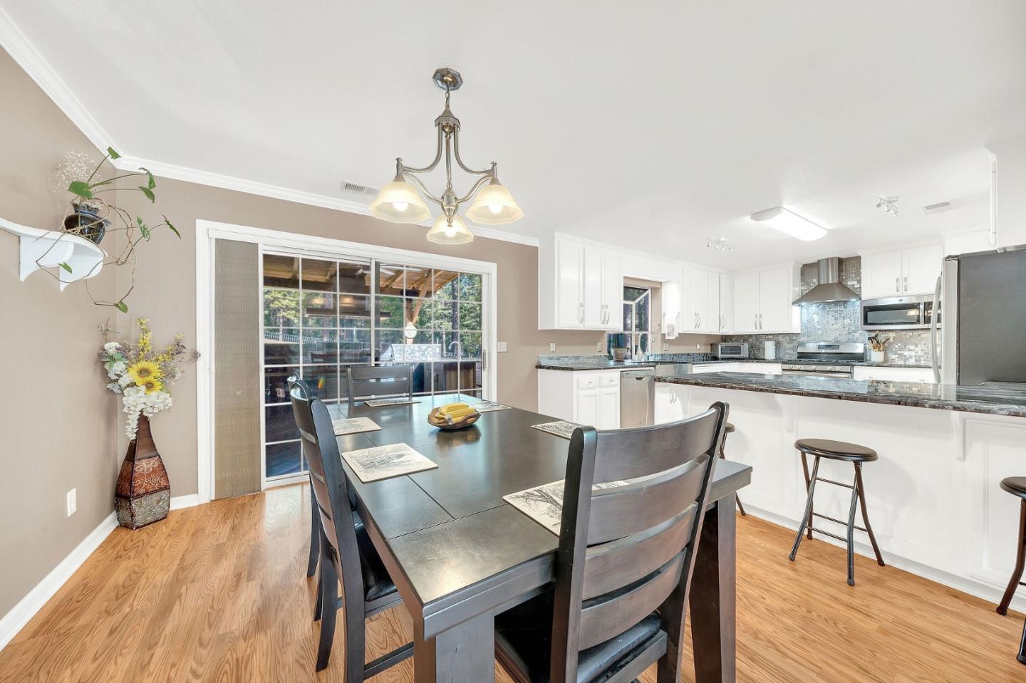 26161 Sugar Pine Drive Pioneer, CA 95666 - Photo 12 of 57 a dining room with furniture a chandelier and wooden floor
