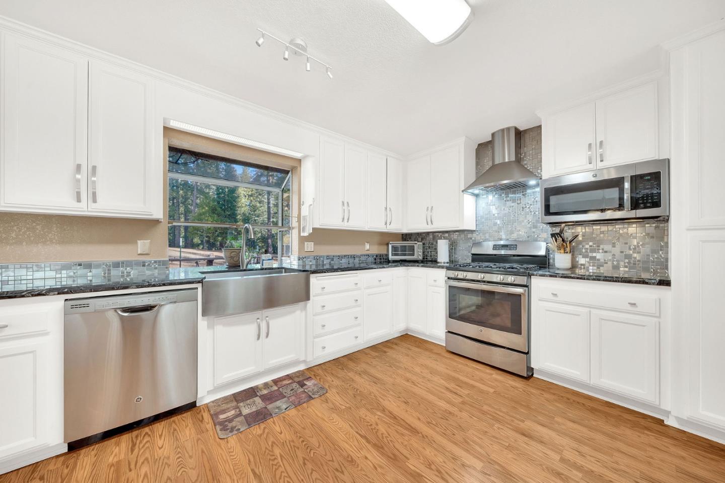26161 Sugar Pine Drive Pioneer, CA 95666 - Photo 20 of 57 a kitchen with granite countertop white cabinets and white appliances