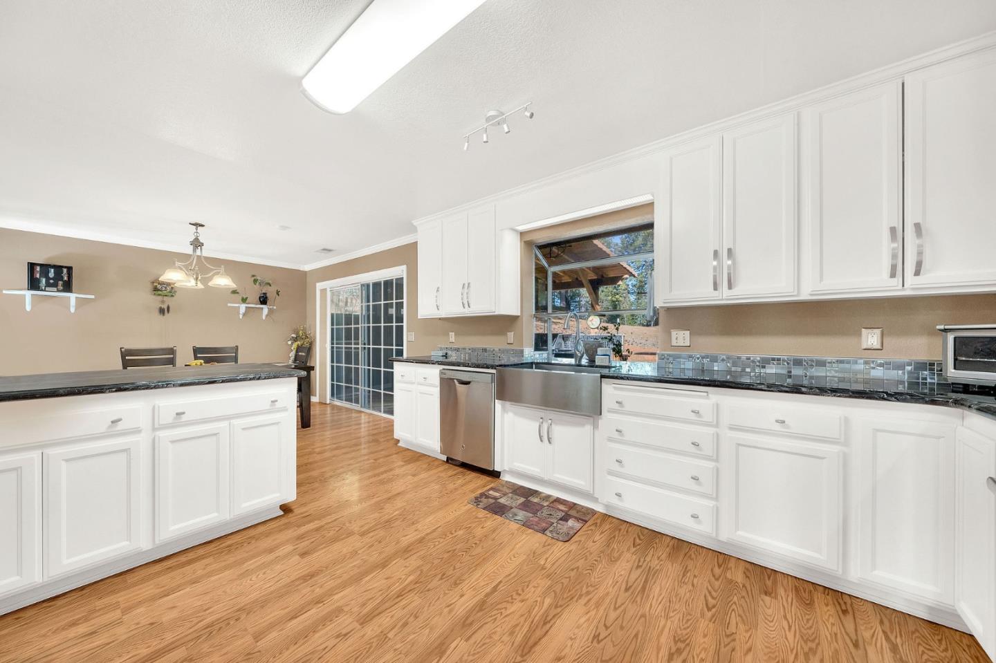 26161 Sugar Pine Drive Pioneer, CA 95666 - Photo 21 of 57 a kitchen with granite countertop white cabinets and white appliances
