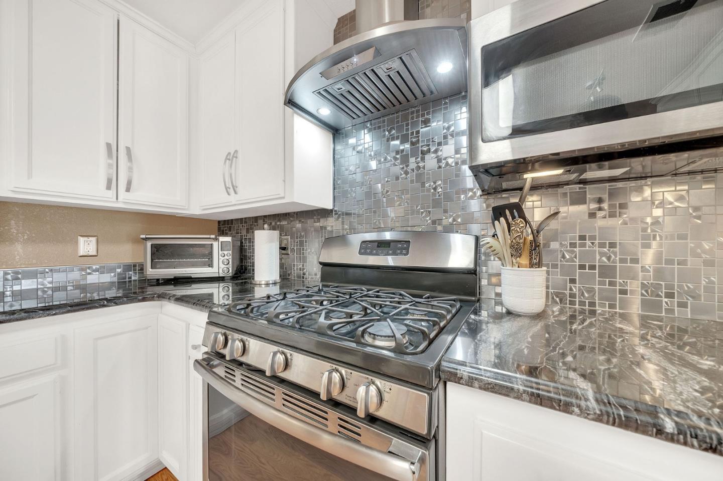 26161 Sugar Pine Drive Pioneer, CA 95666 - Photo 22 of 57 a kitchen with granite countertop a stove sink and cabinets