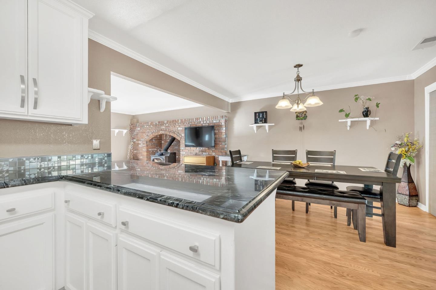 26161 Sugar Pine Drive Pioneer, CA 95666 - Photo 24 of 57 a kitchen with granite countertop a sink a stove and cabinets