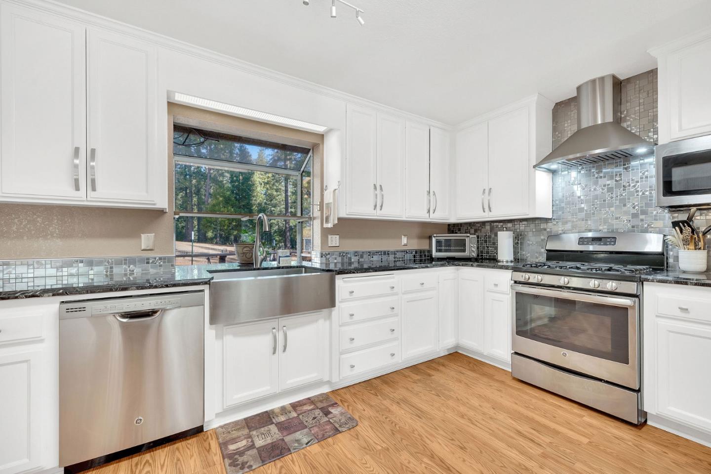 26161 Sugar Pine Drive Pioneer, CA 95666 - Photo 25 of 57 a kitchen with granite countertop white cabinets and white appliances