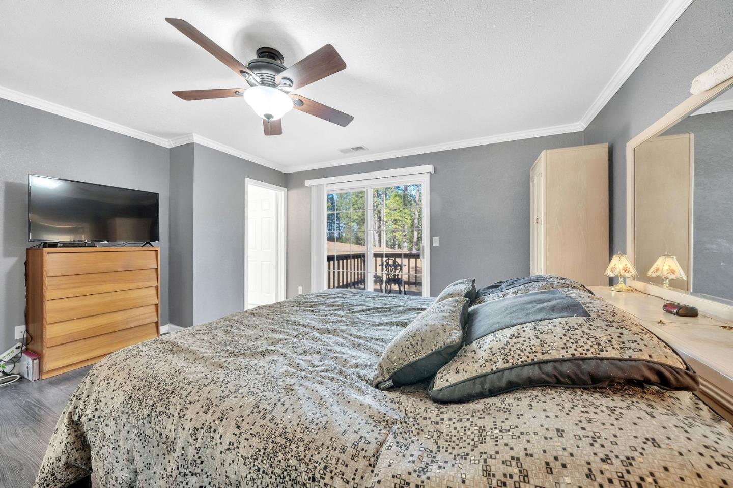 26161 Sugar Pine Drive Pioneer, CA 95666 - Photo 31 of 57 a bedroom with a bed and ceiling fan